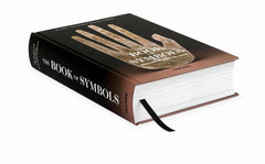 Angled view of the hardback, illustrated hand cover and ribbon bookmark — The Book of Symbols: Reflections on Archetypal Images.